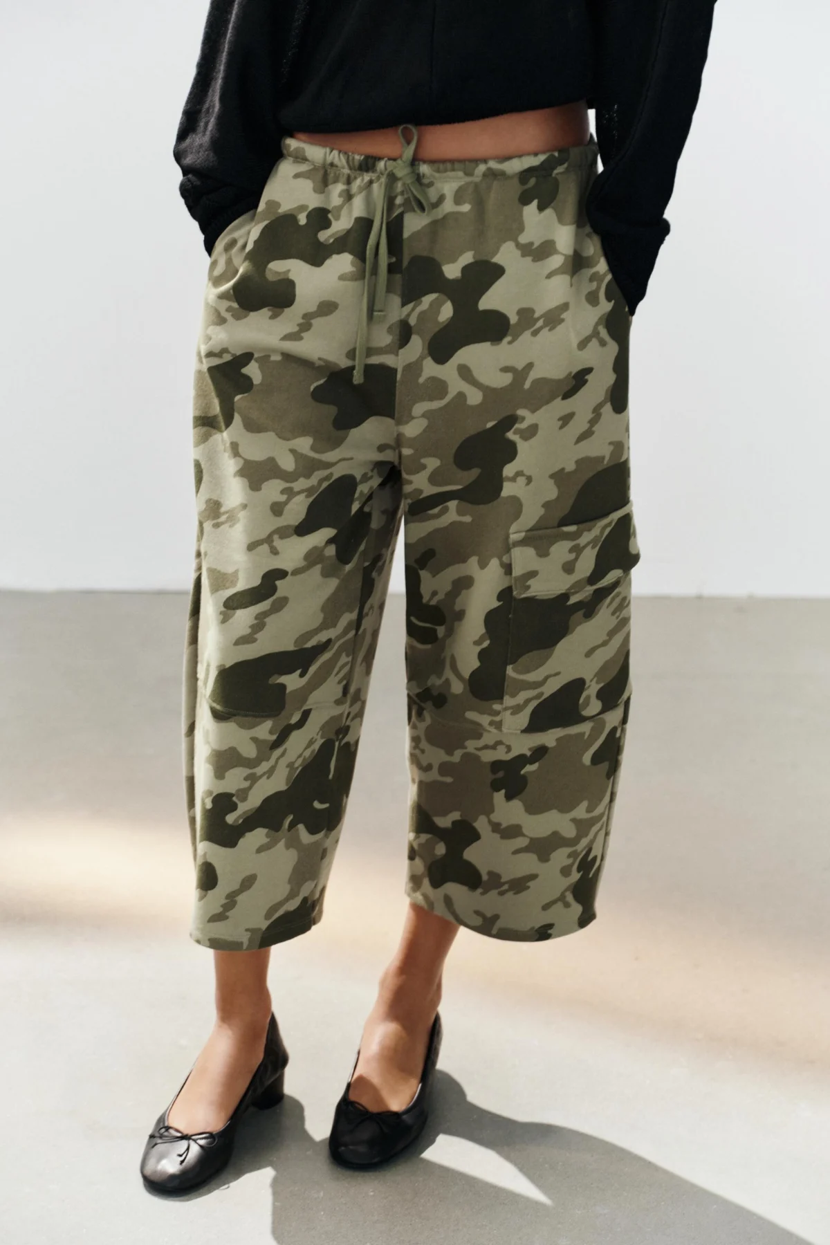 The Art of High-Low Dressing: How Alexa Chung Mastered the Camouflage Pants and Ballet Flats Trend in Paris